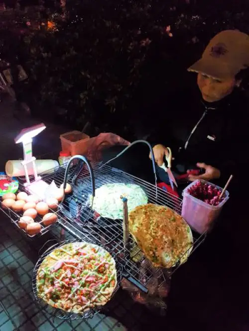 A local food stall selling Dalat pizza in Dalat