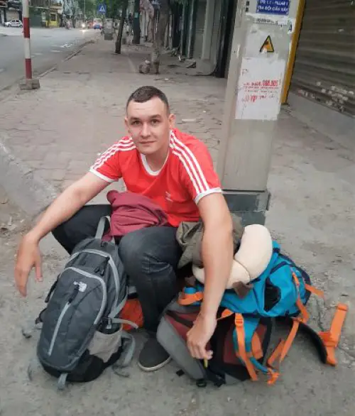 Jake waiting for our taxi with out backpacks in Hanoi