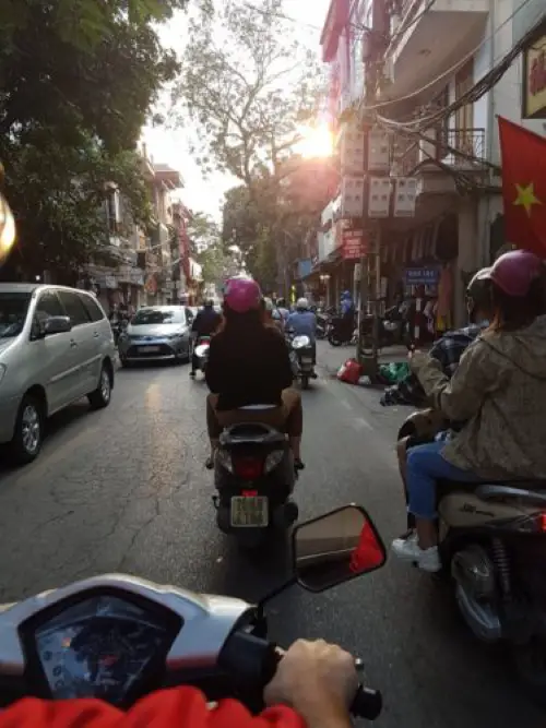 Riding a bike a sunset in Hanoi